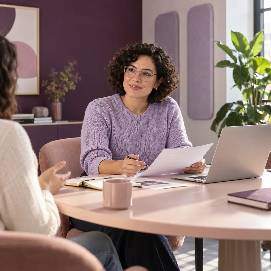 Illustrative scene of two colleagues talking through a document at work